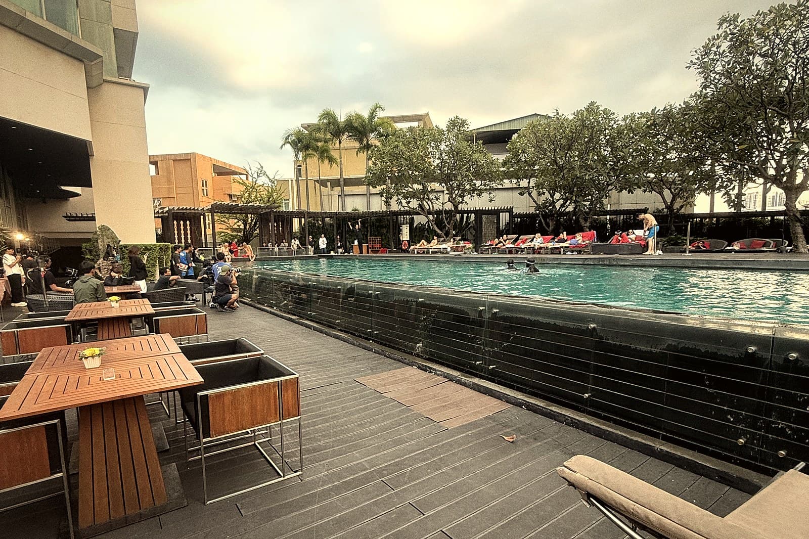 A hotel pool terrace at dusk.